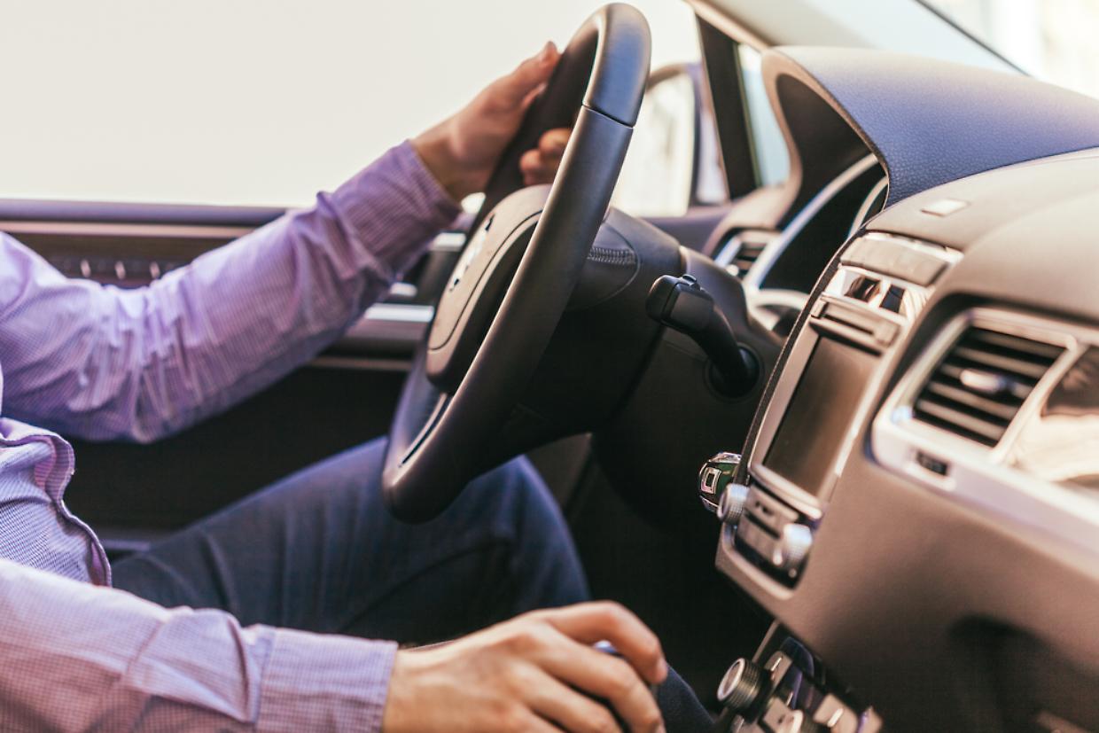 Close-up of a male hand  in a modern car