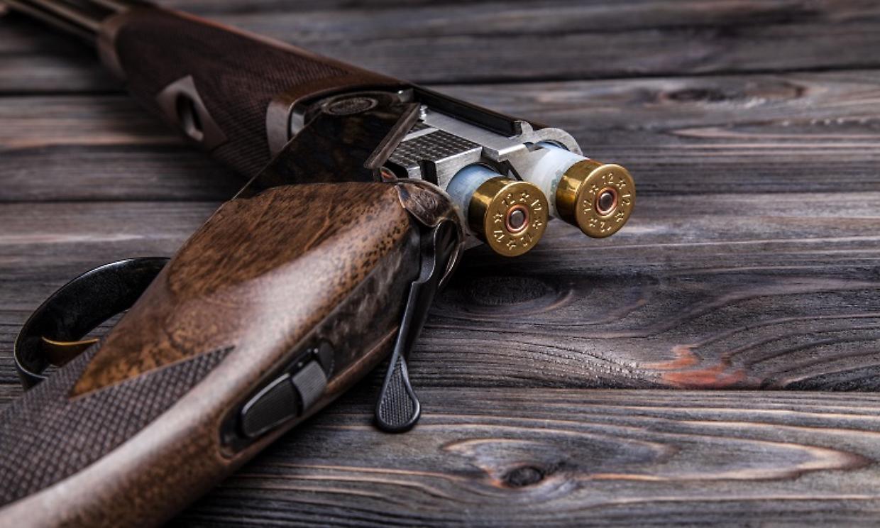 open hunting rifle on a wooden background