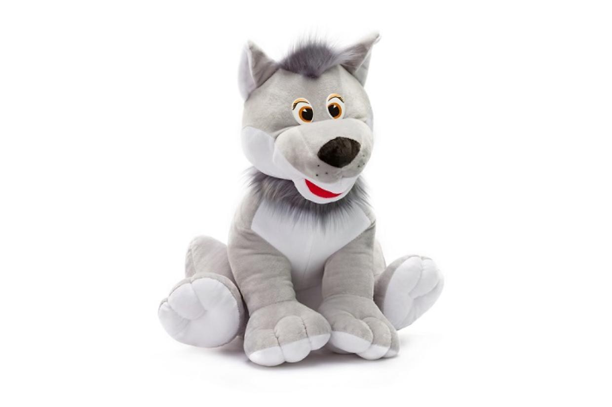 Closeup toy grey soft wolf sitting at isolated white background.