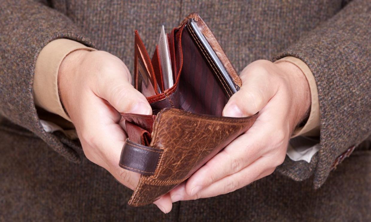 Businessman showing empty wallet. Finance and economy.