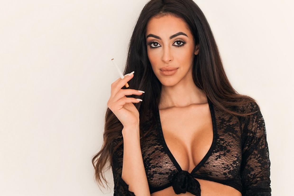 Gorgeous and sensual woman portrait smoking cigarette and lookin