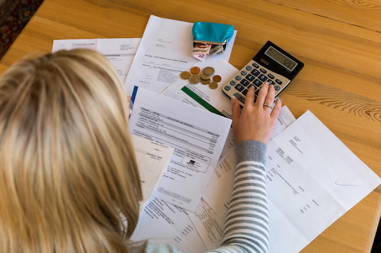 woman with unpaid bills and debts
