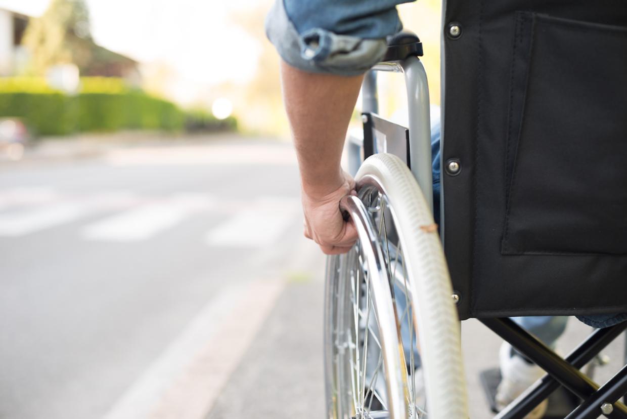 Disabled man preparing to go across the road