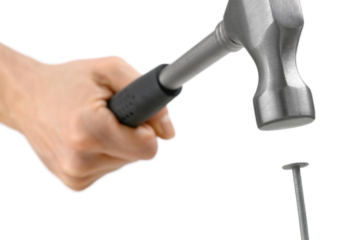 Hammer in action, isolated on white