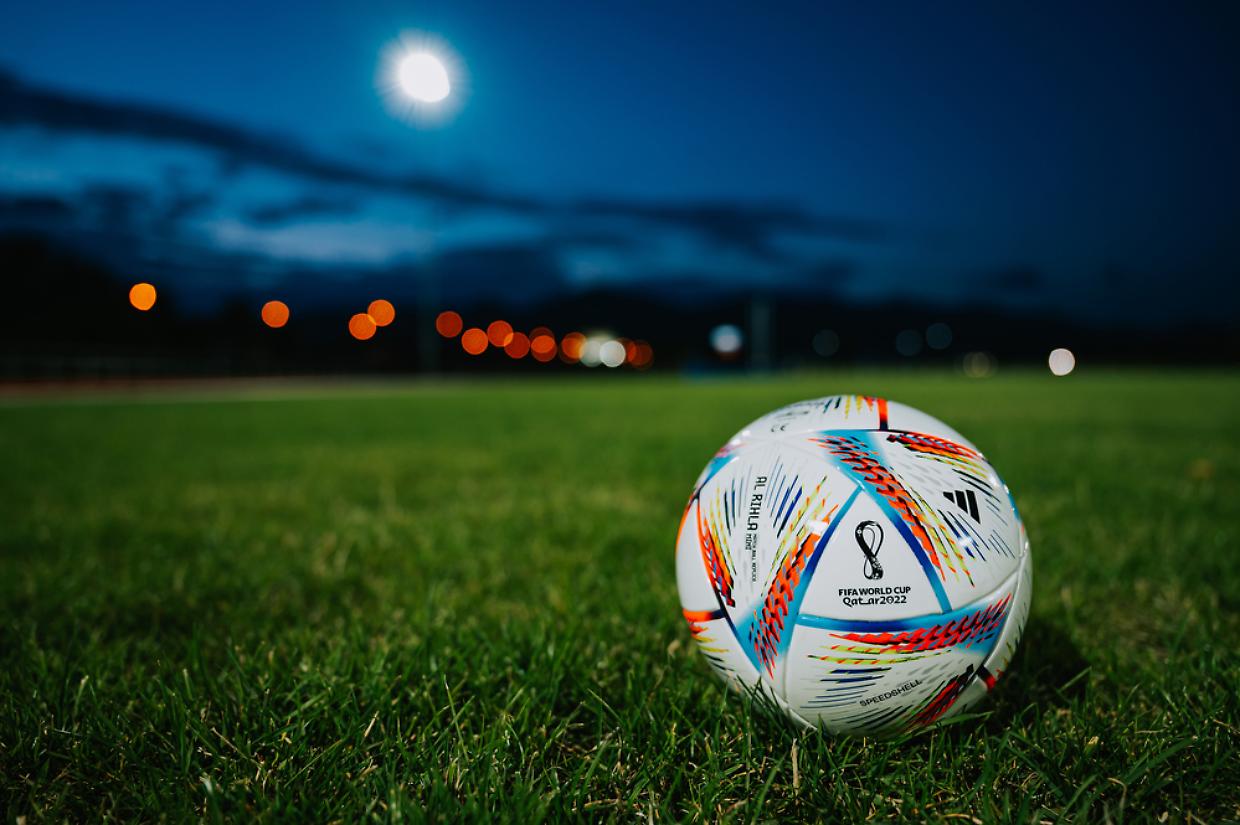 mondiale qatar 2022 QATAR, DOHA, 18 JULY, 2022: Official Adidas Fifa World Cup Football Ball Al Rihla. World Championship in Qatar 2022. Soccer Match Ball on green grass in night at Stadium. FIFA 22, black edit space.