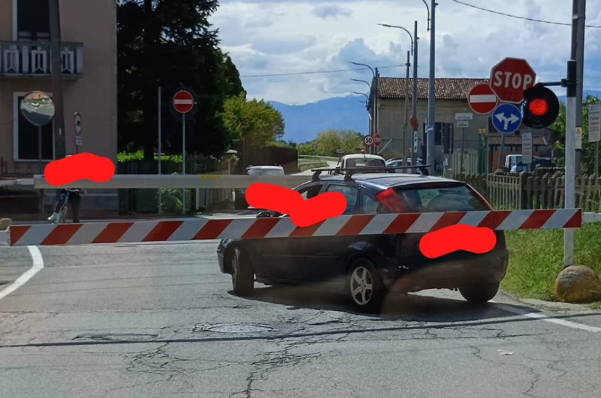 L'auto rimasta bloccata poco fa tra le sbarre di un passaggio a livello a Chivasso (Fonte Facebook)