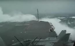 Il mare in burrasca sferza il ponte della portaerei